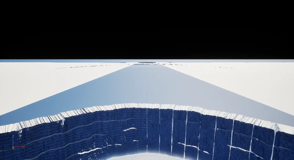 Unlit editor capture from above: a long wall of blue ice blocks curving away across white ground